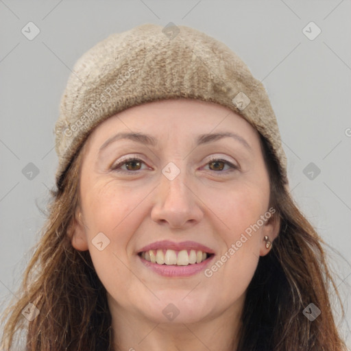 Joyful white adult female with long  brown hair and brown eyes