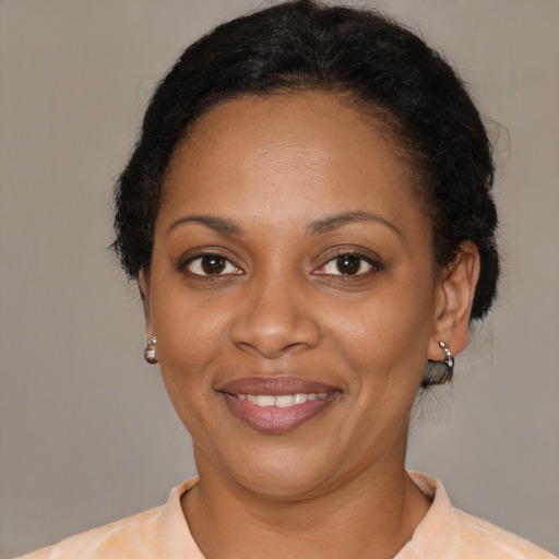 Joyful black young-adult female with short  brown hair and brown eyes