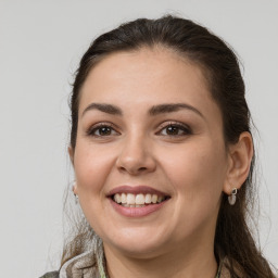 Joyful white young-adult female with medium  brown hair and grey eyes