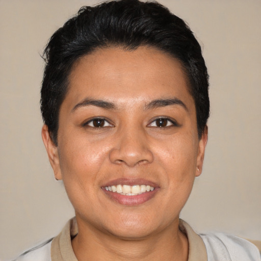 Joyful latino young-adult female with short  black hair and brown eyes