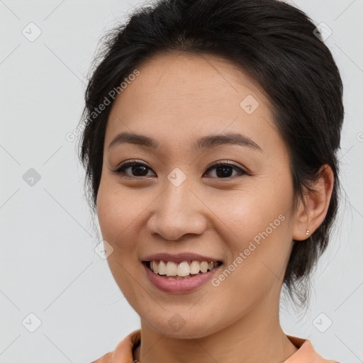 Joyful white young-adult female with medium  brown hair and brown eyes