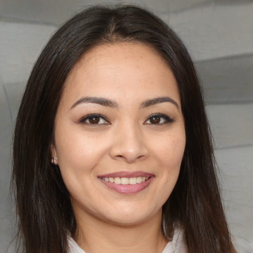 Joyful white young-adult female with long  brown hair and brown eyes