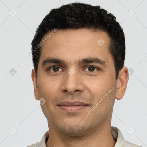 Joyful white young-adult male with short  black hair and brown eyes