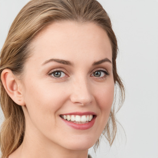 Joyful white young-adult female with medium  brown hair and blue eyes