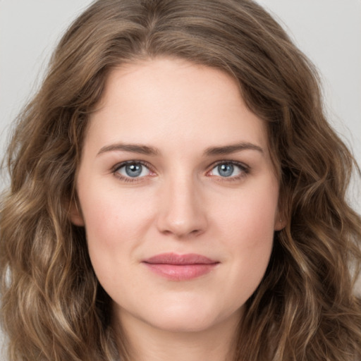 Joyful white young-adult female with long  brown hair and green eyes