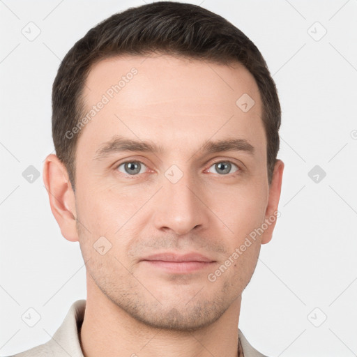 Joyful white young-adult male with short  brown hair and grey eyes