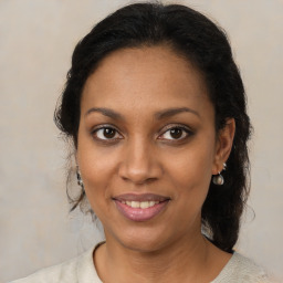 Joyful black young-adult female with medium  brown hair and brown eyes