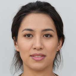 Joyful asian young-adult female with medium  brown hair and brown eyes