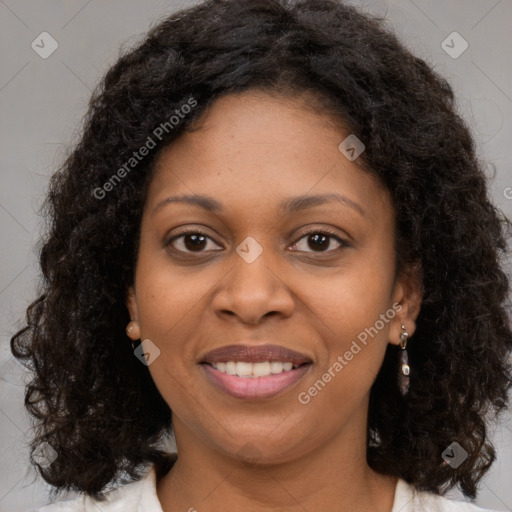 Joyful black young-adult female with long  brown hair and brown eyes