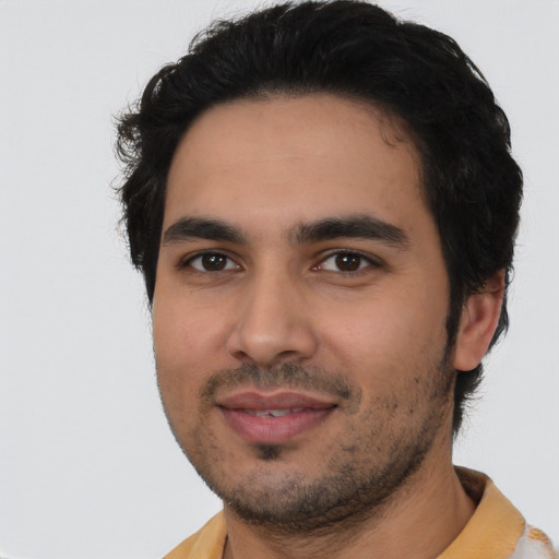 Joyful latino young-adult male with short  black hair and brown eyes