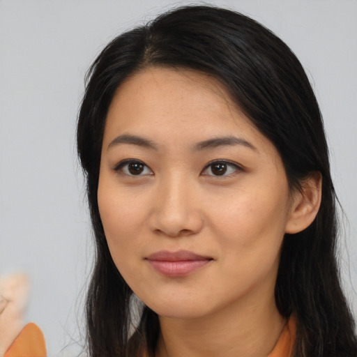 Joyful asian young-adult female with long  black hair and brown eyes