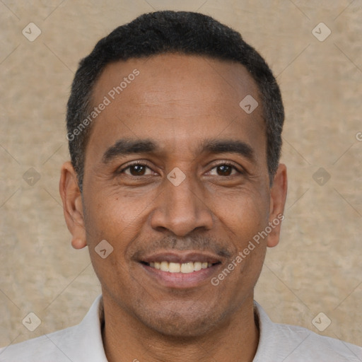 Joyful latino adult male with short  black hair and brown eyes