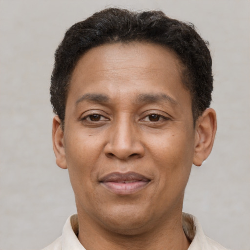 Joyful latino adult male with short  brown hair and brown eyes