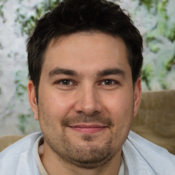 Joyful white adult male with short  brown hair and brown eyes