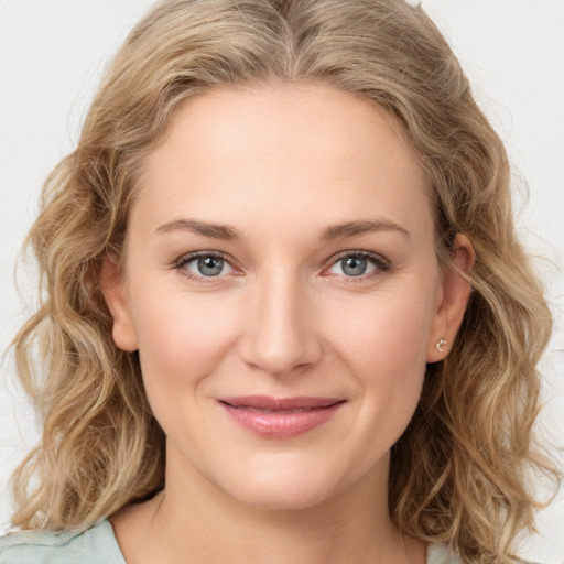 Joyful white young-adult female with medium  brown hair and blue eyes