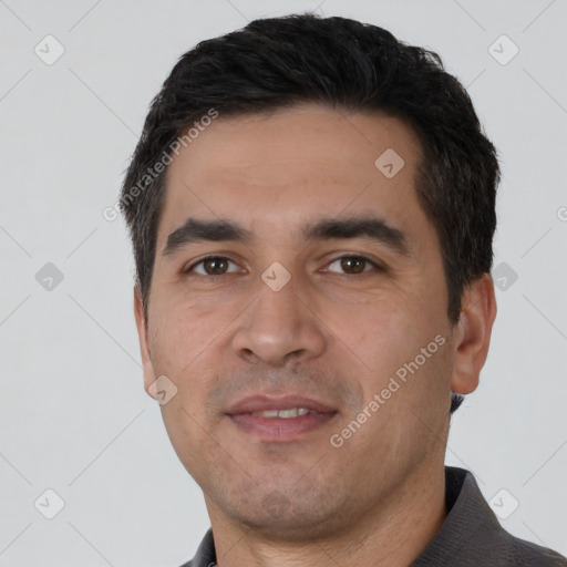 Joyful white young-adult male with short  black hair and brown eyes