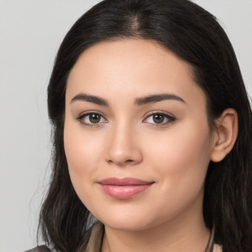 Joyful latino young-adult female with long  brown hair and brown eyes