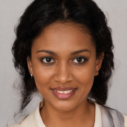 Joyful black young-adult female with medium  brown hair and brown eyes