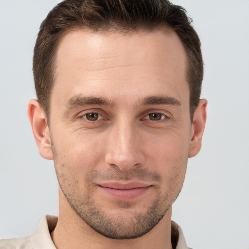 Joyful white young-adult male with short  brown hair and brown eyes