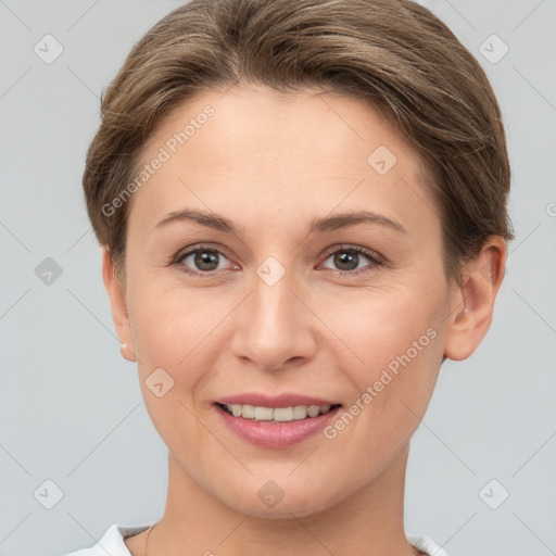 Joyful white young-adult female with short  brown hair and grey eyes