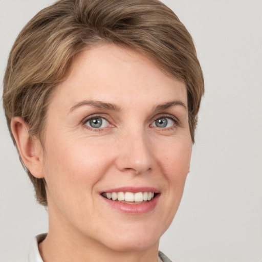 Joyful white young-adult female with short  brown hair and grey eyes