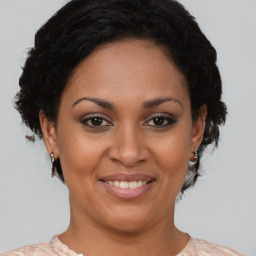 Joyful black adult female with short  brown hair and brown eyes