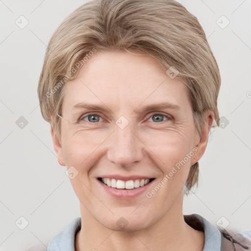 Joyful white adult female with short  brown hair and grey eyes