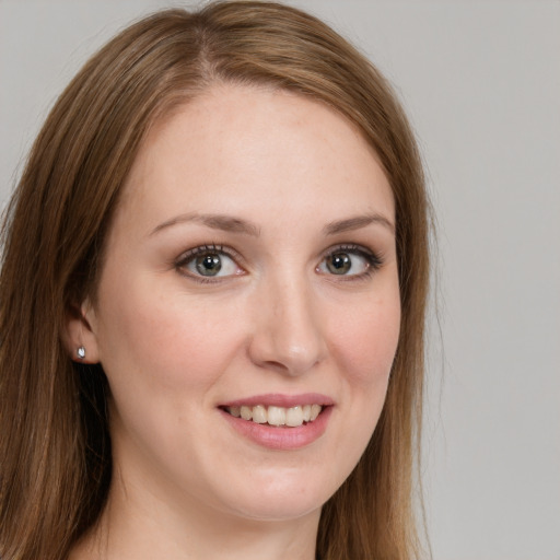 Joyful white young-adult female with long  brown hair and green eyes