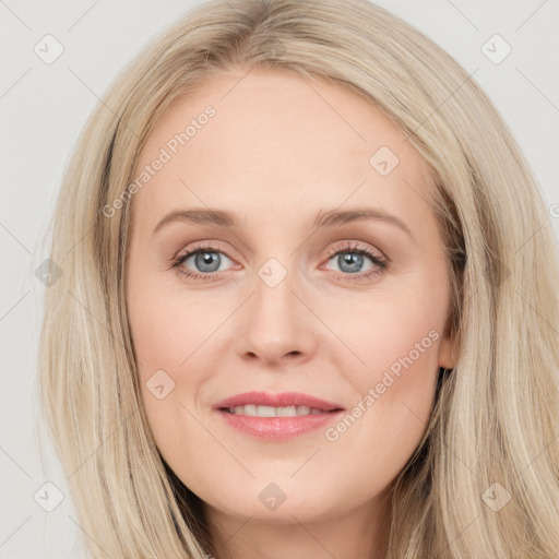 Joyful white young-adult female with long  brown hair and blue eyes