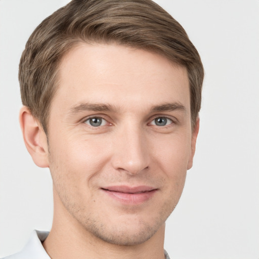 Joyful white young-adult male with short  brown hair and grey eyes