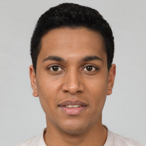 Joyful latino young-adult male with short  black hair and brown eyes
