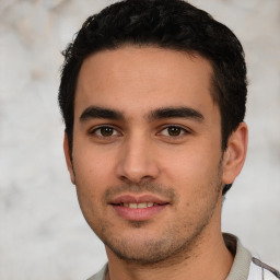 Joyful white young-adult male with short  black hair and brown eyes