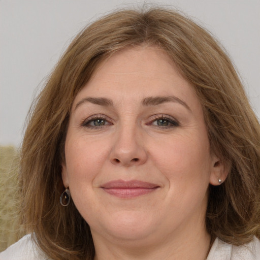 Joyful white adult female with medium  brown hair and brown eyes