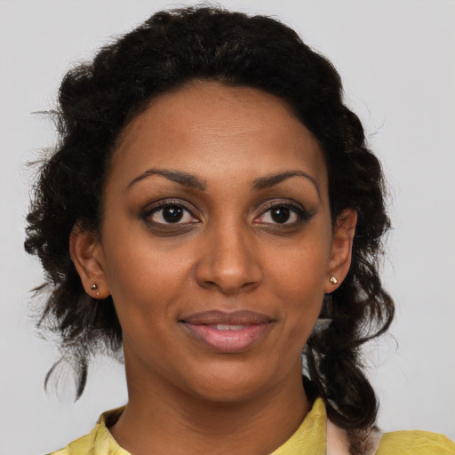Joyful black young-adult female with medium  brown hair and brown eyes