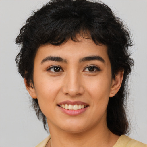 Joyful latino young-adult female with medium  brown hair and brown eyes