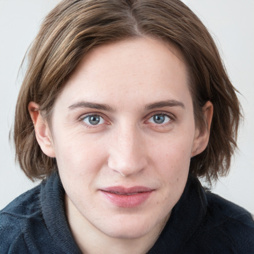 Joyful white young-adult female with long  brown hair and blue eyes