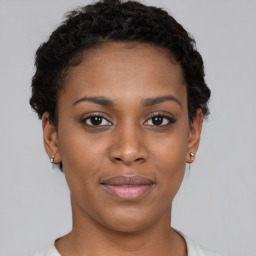 Joyful black young-adult female with short  brown hair and brown eyes