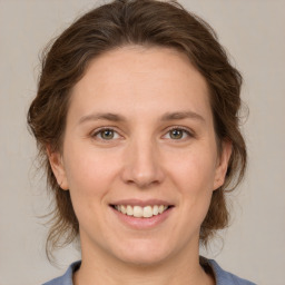 Joyful white adult female with medium  brown hair and grey eyes