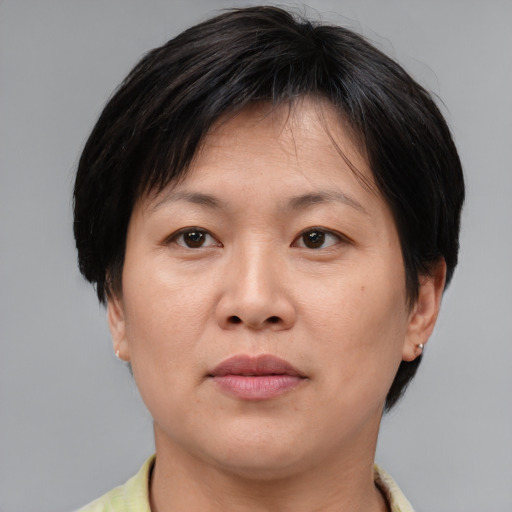 Joyful asian adult female with medium  brown hair and brown eyes