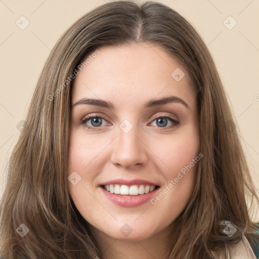 Joyful white young-adult female with long  brown hair and green eyes