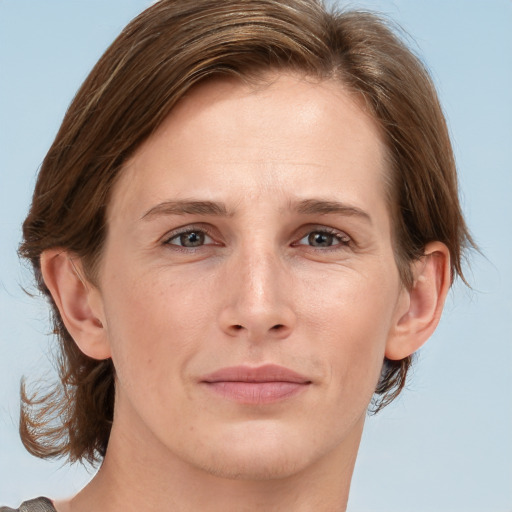 Joyful white adult female with medium  brown hair and grey eyes