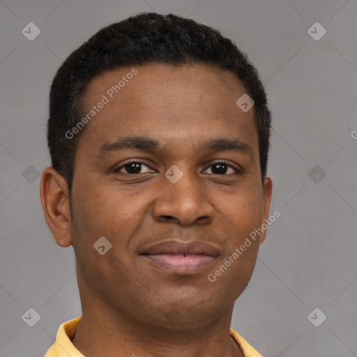 Joyful black young-adult male with short  brown hair and brown eyes