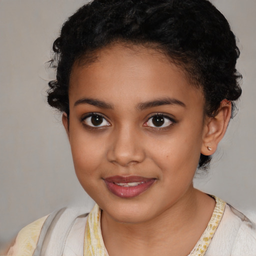 Joyful latino child female with medium  brown hair and brown eyes