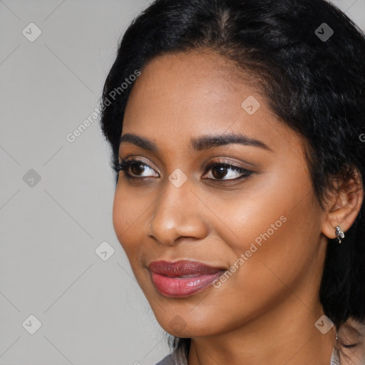 Joyful latino young-adult female with long  black hair and brown eyes