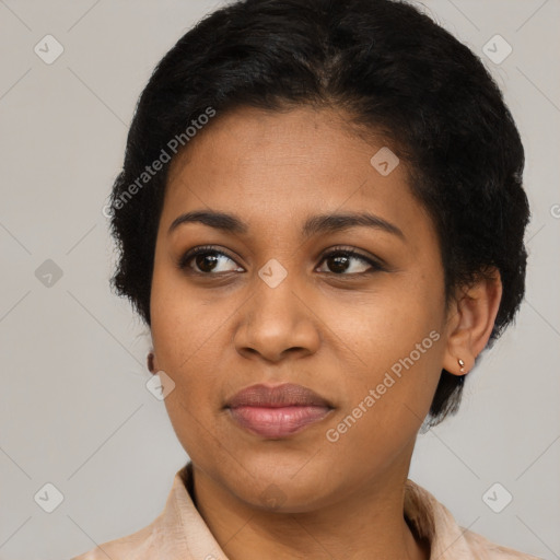 Joyful black young-adult female with short  brown hair and brown eyes