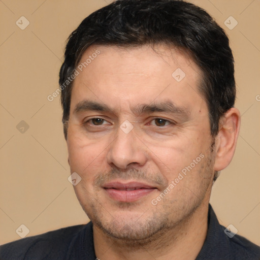 Joyful white adult male with short  black hair and brown eyes