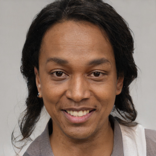 Joyful black young-adult female with medium  brown hair and brown eyes