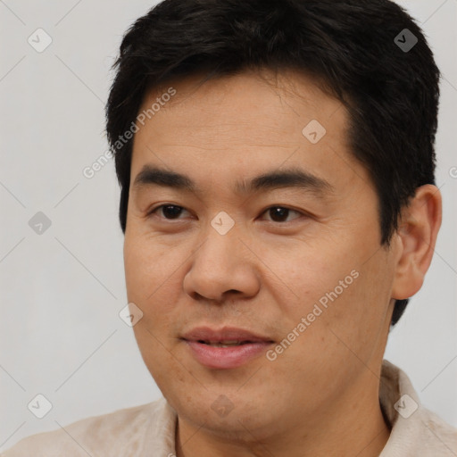 Joyful asian young-adult male with short  black hair and brown eyes