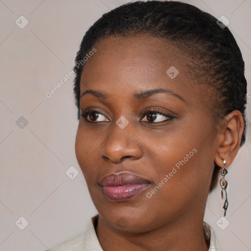 Joyful black young-adult female with medium  brown hair and brown eyes