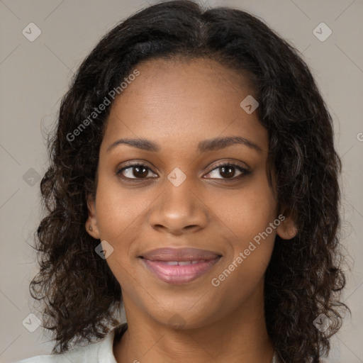 Joyful black young-adult female with long  brown hair and brown eyes